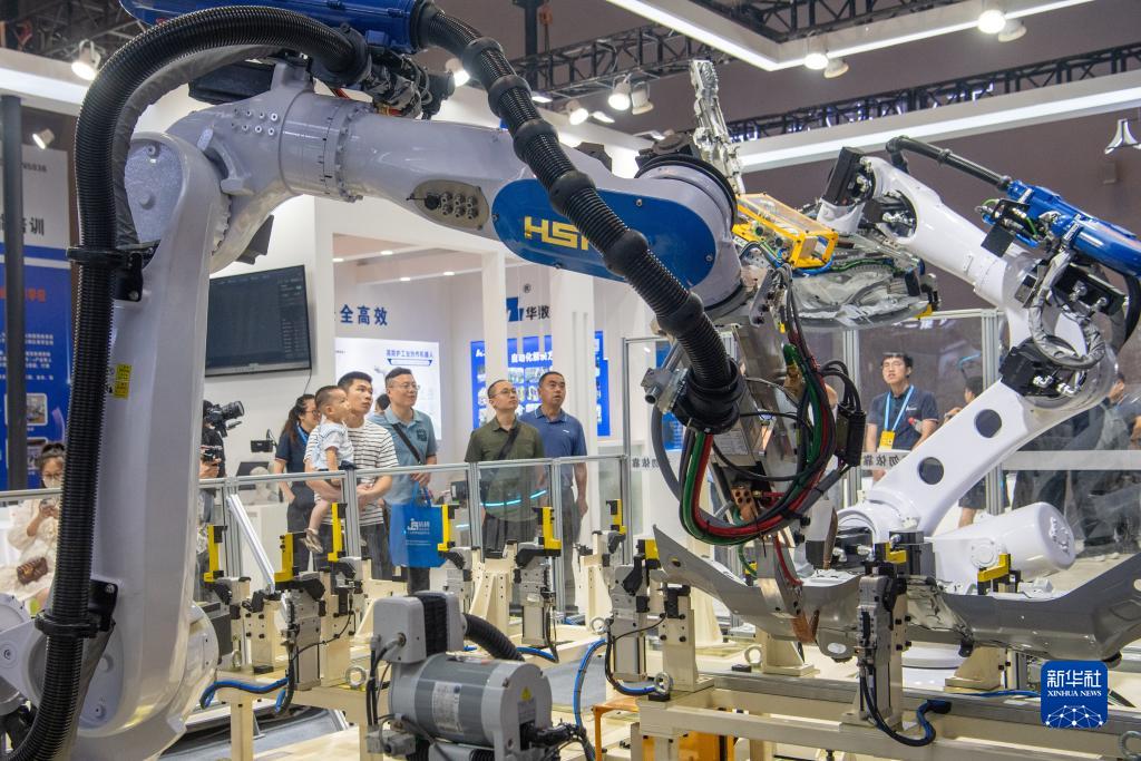 9月4日，在2023智博會(huì)華數(shù)機(jī)器人展廳，嘉賓參觀機(jī)器人工作設(shè)備。新華社記者 唐奕 攝